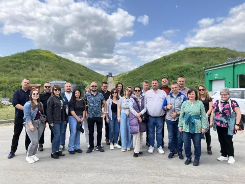 grupa ludzi pozuje do zdjęcia na dworzu